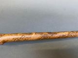 a wooden stick with writing on it sitting on a table