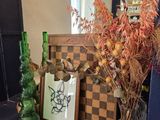 a vase of flowers and a picture on a shelf