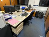 a desk with two monitors and a printer on it
