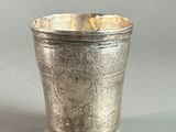 a silver cup that is sitting on a table