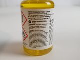 a small bottle of liquid sitting on a table