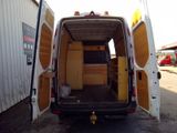 a white van with its doors open in a parking lot