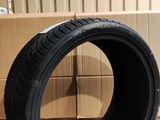 tire on the floor next to cardboard boxes in a warehouse