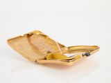 a small gold cigarette case with a cigarette in it