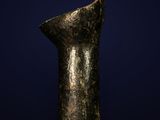 an ancient bronze statue of a woman ' s head on a blue background