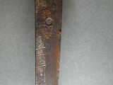 a close up of a very old knife on a table