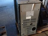 a old furnace sitting on a pallet in a garage