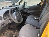 a small yellow car that is parked on the side of the road