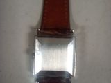 a watch that is sitting on a white surface