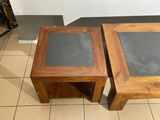 two tables that are sitting side by side on a tiled floor