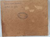 an old brown box with a stamp on it sitting on a table