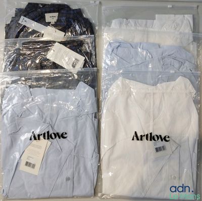 three shirts that are in a plastic box