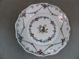 a white plate with blue and yellow designs on it