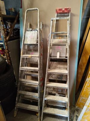 two ladders sitting next to each other in a room