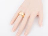 a close up of a person ' s hand with a gold ring on it