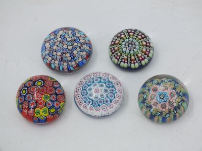 six glass magnets with different designs on them on a white surface