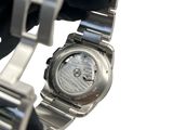 a watch that is being held up by a glove