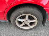 a close up of a red car with a flat tire