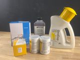 a bottle of detere, a container of liquid, and a box of soap