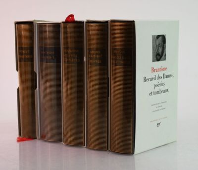 three books sitting on top of a white table next to each other
