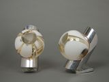 two silver and white knobs on a gray surface