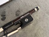 a knife and a pen on the ground next to a laptop