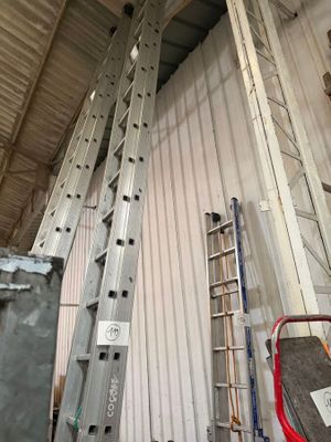 many ladders that are leaning against the wall