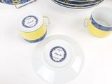 two cups and a saucer sitting on a table