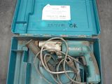 a blue box with a drill and a cord in it
