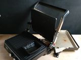 une grille noire et argentée posée sur une table en bois