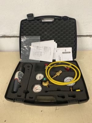 an image of a case with a hose and gauges in it