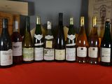 several bottles of wine are lined up on a red table