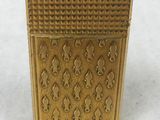 gold plated box with ornate design on it on a white surface