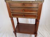an image of a small wooden table with three drawers on top of it