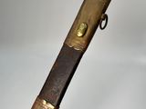 a close up of a wooden stick with a metal handle on a white background