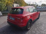 a red car that is parked in a parking lot