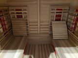 a sauna room with a lot of shelves on the wall