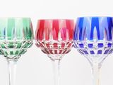 three wine glasses sitting next to each other on a table