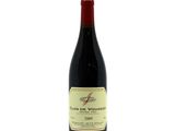 a bottle of red wine sitting on top of a white table
