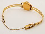 bracelet with a gold colored metal clasp and a gold colored metal clasp