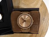 michael korsch watch in a box on a wooden table