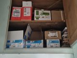 many boxes of mail sitting on a shelf above a door