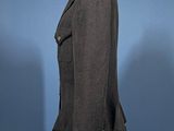 the back of a black jacket on a mannequin mannequin stand