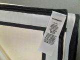 a black and white striped bag with a tag on it