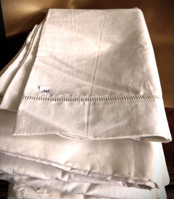 a stack of folded linens on a wooden table