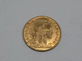 a close up of a gold coin on a white surface