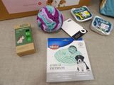 a box of yarn, a ball of yarn, and other items on a table