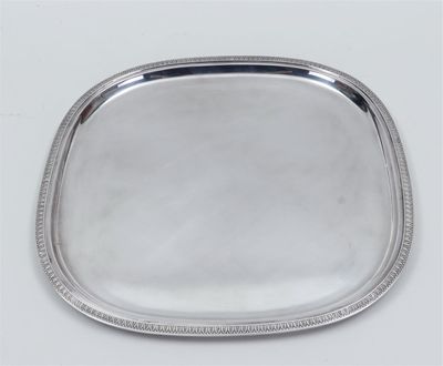 a silver tray with beaded edge on a white surface