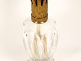 a glass bottle with a gold top and a gold crown on the top