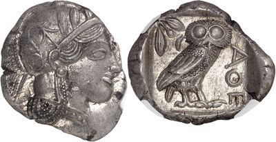 a silver coin with an image of a woman and an owl on it